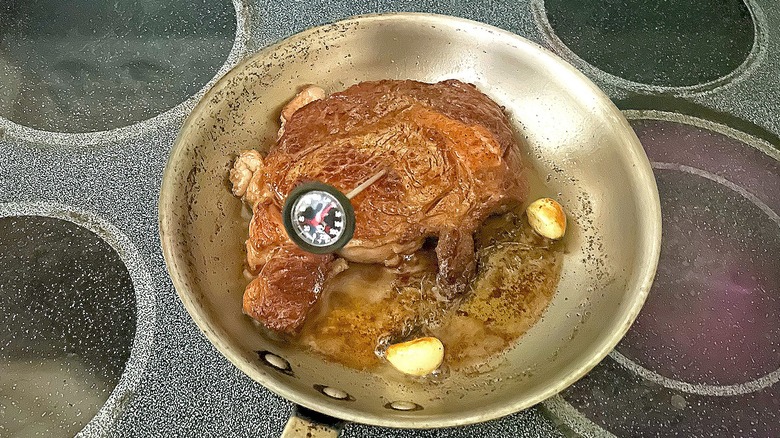 Taking temperature of steak