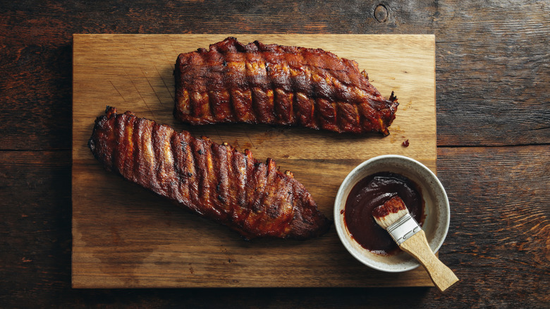 meat with bowl of barbecue sauce 