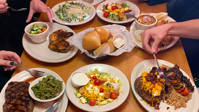Salad with a fork on a wooden table at Texas Roadhouse