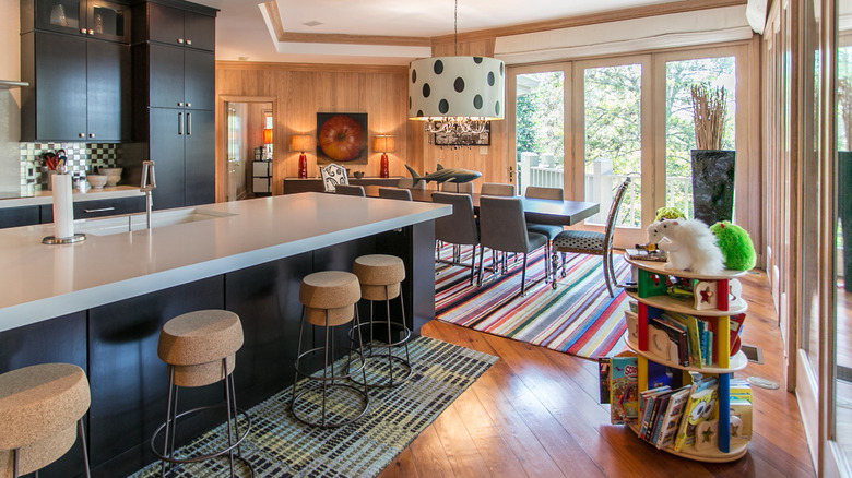 Geometric kitchen with multiple striped rugs.