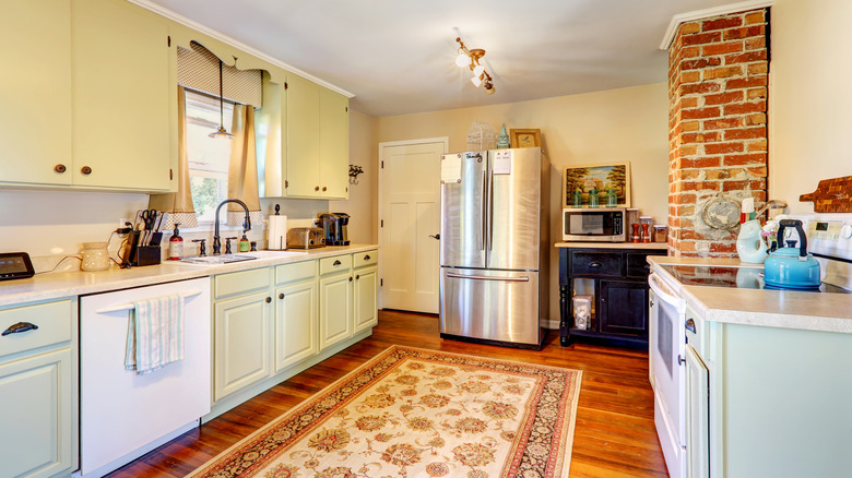 Cozy kitchen with a large, floral rug.