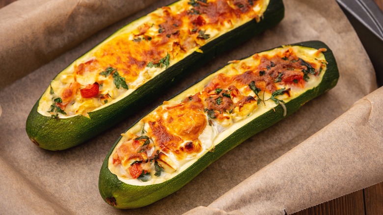 Zucchini stuffed with feta cheese, egg, parsley and cherry tomatoes