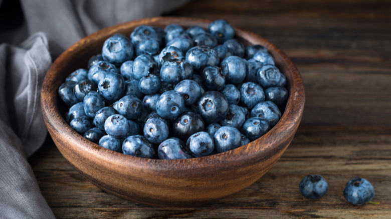 Blueberries in a wooden bowl on a table