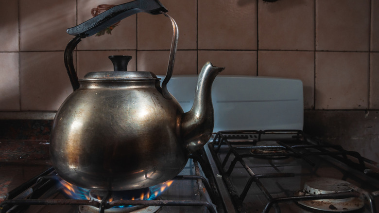 A vintage kettle on a stovetop.