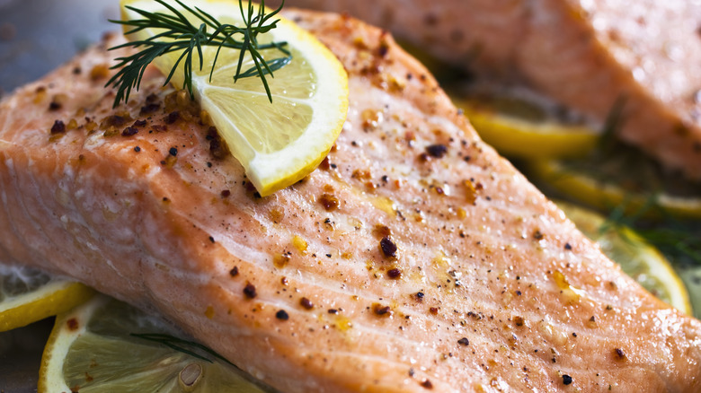 Close-up of salmon with lemon slices and pepper