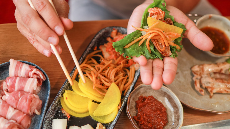 Various ingredients displayed in dishes for a Korean BBQ ssam