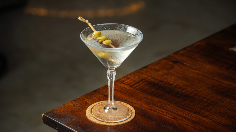 A dirty martini on a table.