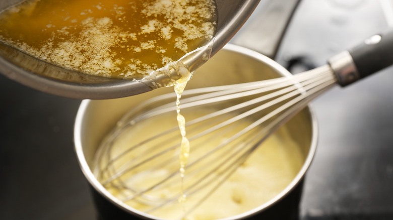 adding butter to hollandaise sauce