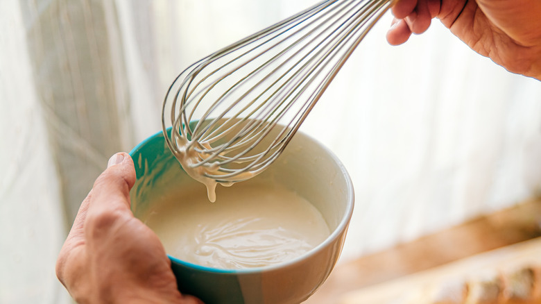 whisking sauce in bowl