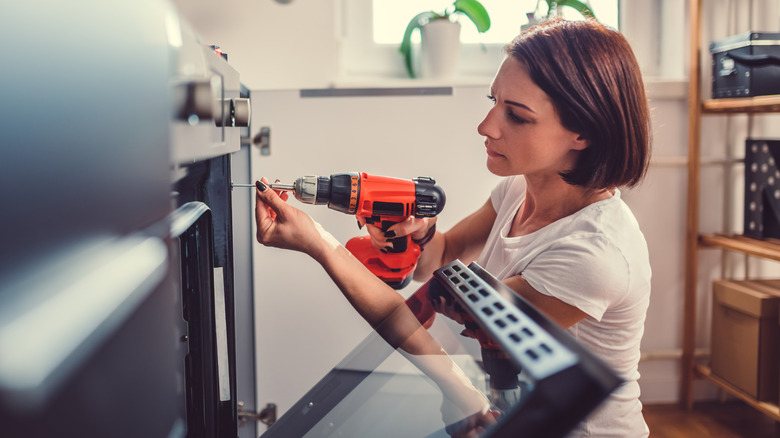 Woman installing an oven