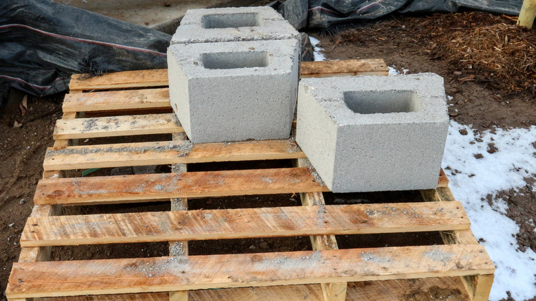 Wooden pallet and cement blocks