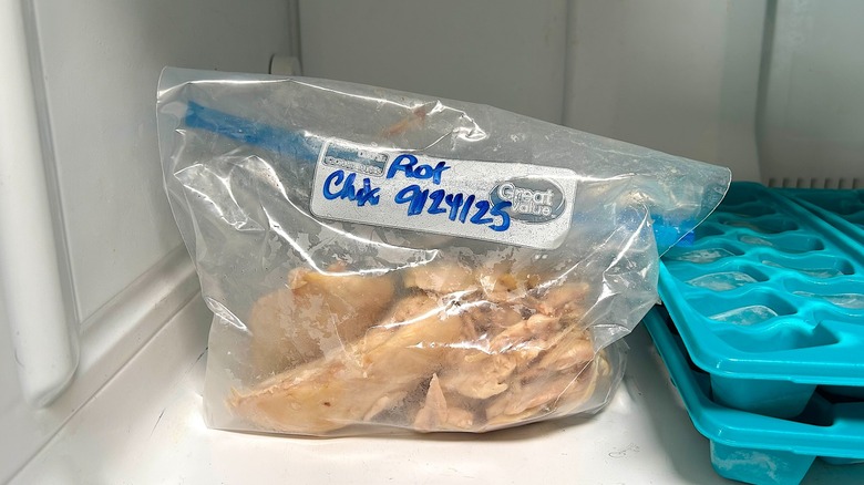 Rotisserie chicken meat in a Ziploc bag placed in the freezer