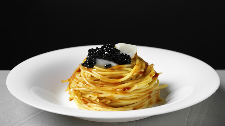 A plate of spaghetti topped with caviar