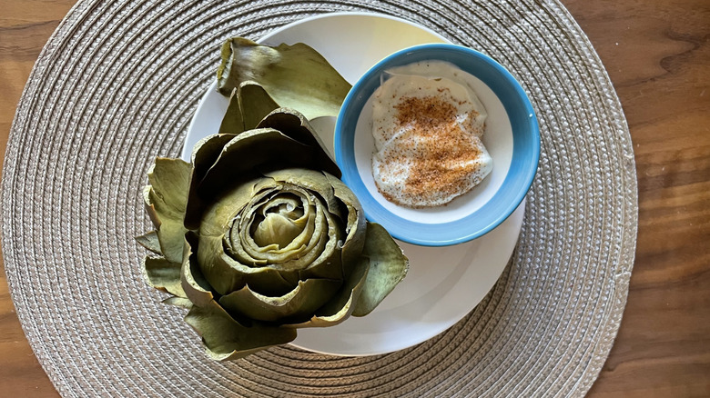 cooked artichoke with mayonnaise dipping sauce