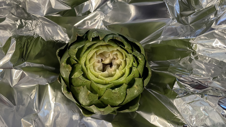 Prepped artichoke in tin foil
