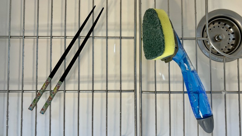 Chopsticks and sponge in sink
