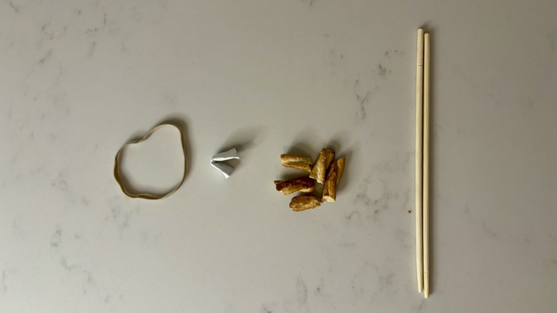 Rubberband, paper, broken pretzels, chopsticks