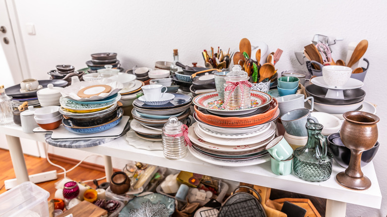 Kitchen clutter, utensils and kitchenware on a table.