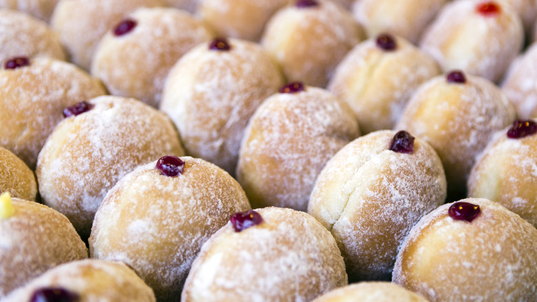 Powdered sugar donuts filled with jelly
