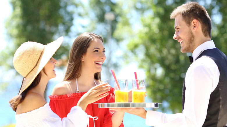 Women conversing with wait staff