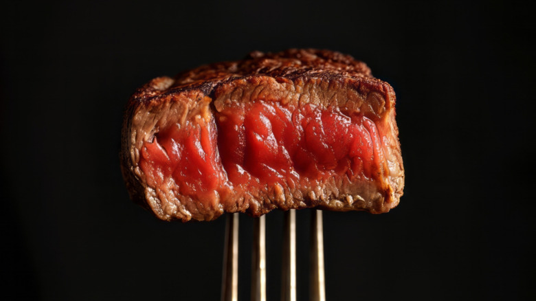 Bite of steak on a fork