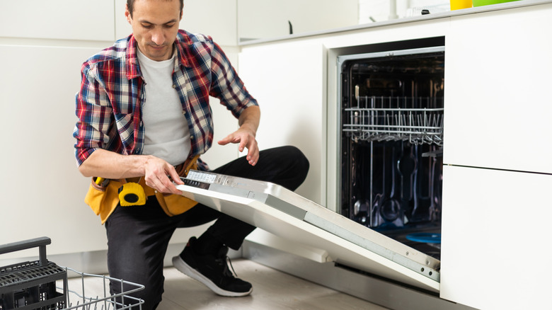 Man repairing dishwasher