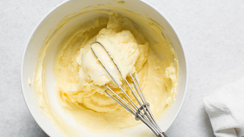 Buttercream in a bowl with a whisk