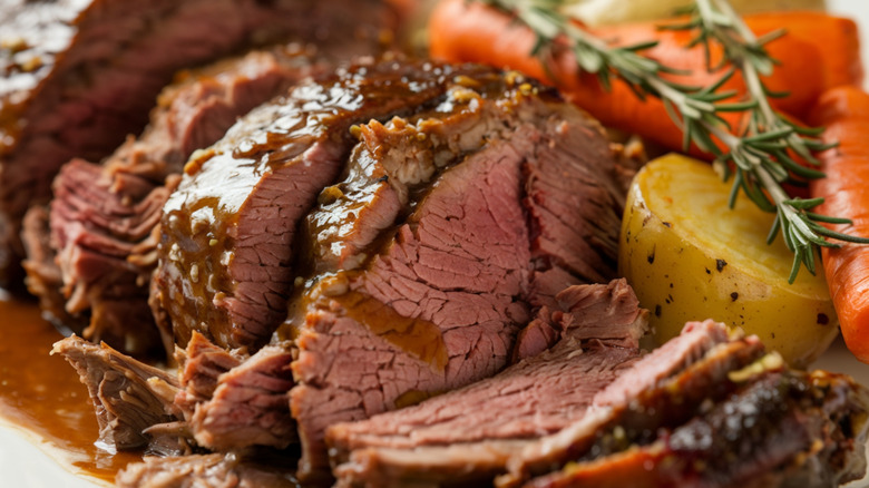 Tender beef pot roast with potatoes, carrots, and rosemary