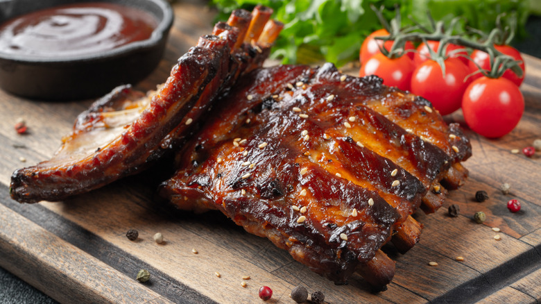 Roasted barbecue pork ribs on a wooden board.