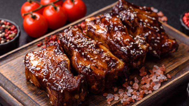 Grilled or barbecue pork ribs with sauce and sesame seeds.