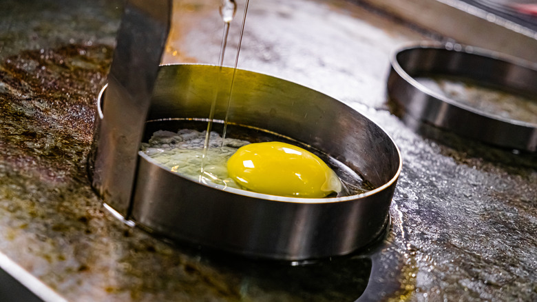 Eggs cooking in egg rings