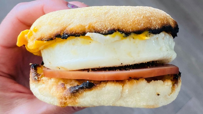 Hand holding an Egg McMuffin