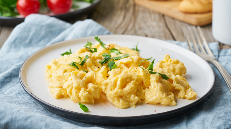 Scrambled eggs on a wooden table.