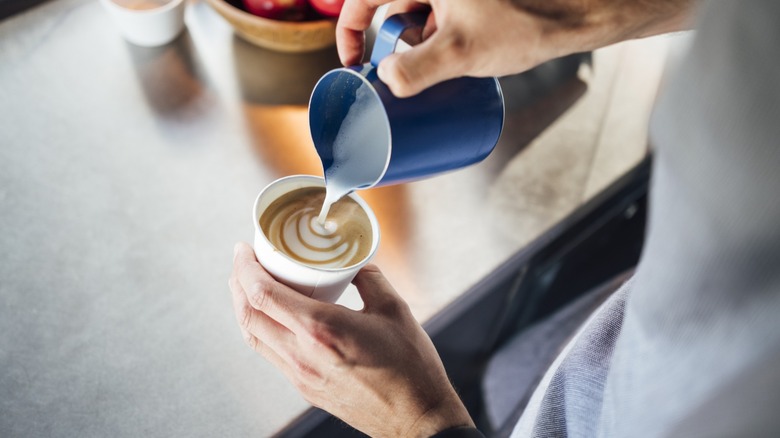 A barista making latte art