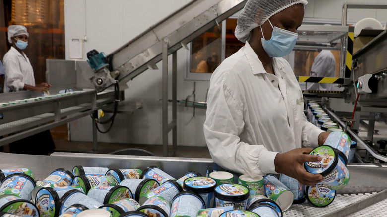 Ben & Jerry's workers inspecting ice cream pints inside a production plant