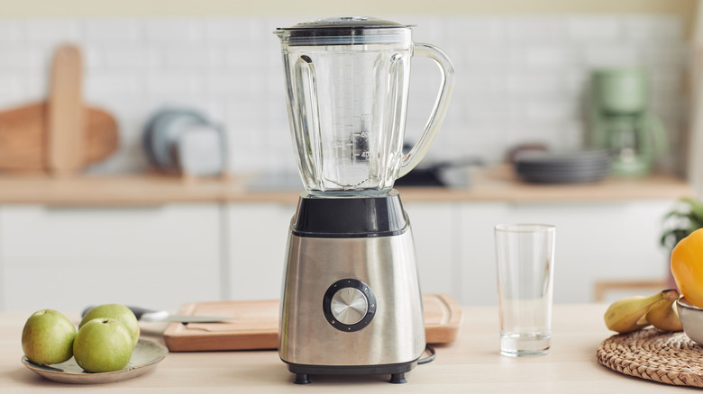 blender sitting on a counter with fruit