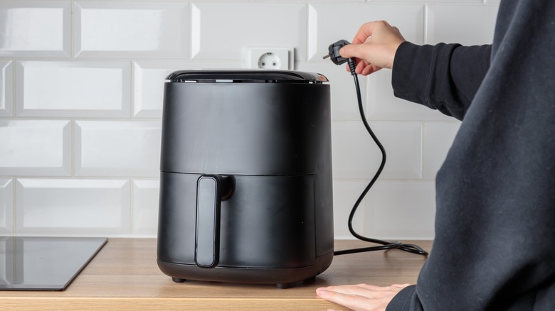 Black air fryer on kitchen counter