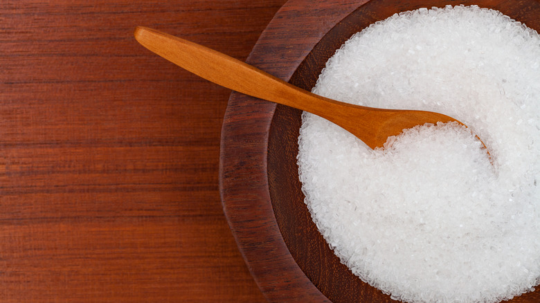 Epsom salt in a bowl on a wooden table.