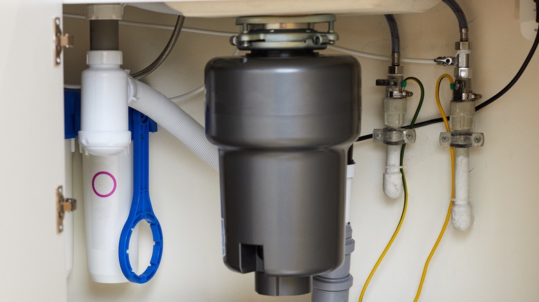 garbage disposal unit hanging under sink