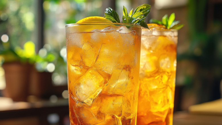Refreshing drinks in tall glasses packed with ice