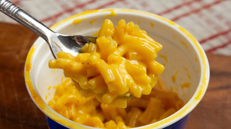Microwavable mac and cheese cup with a spoon