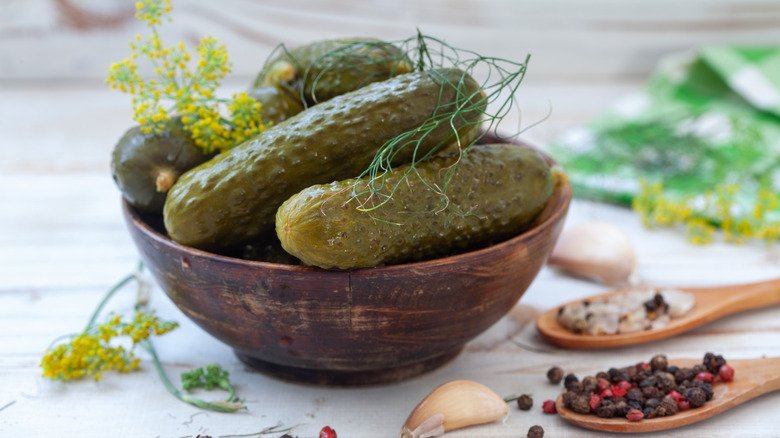 pickles in a bowl sitting on a white countertop