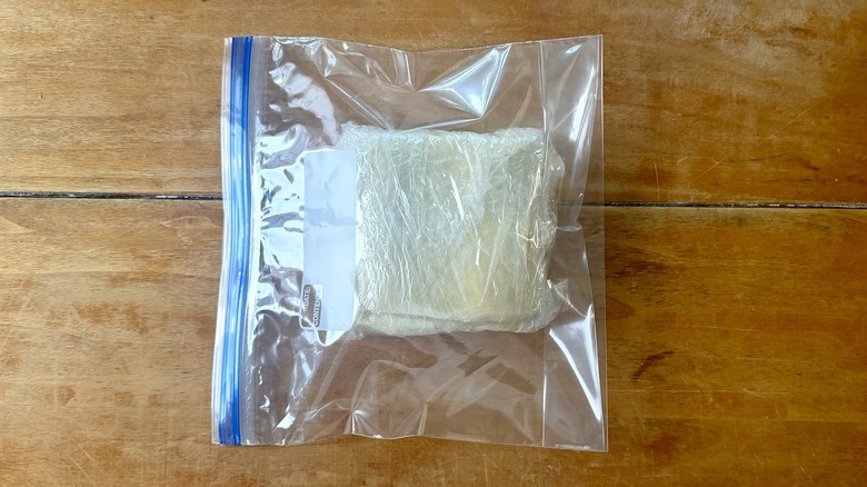 a laminated puff pastry inside a ziplock bag on a wooden table