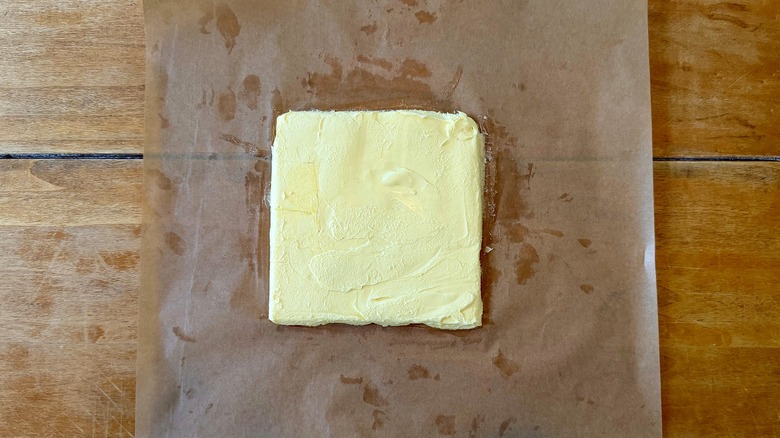 a butter block on brown parchment paper