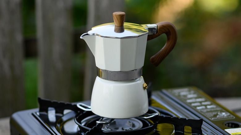 A moka pot on a gas burner