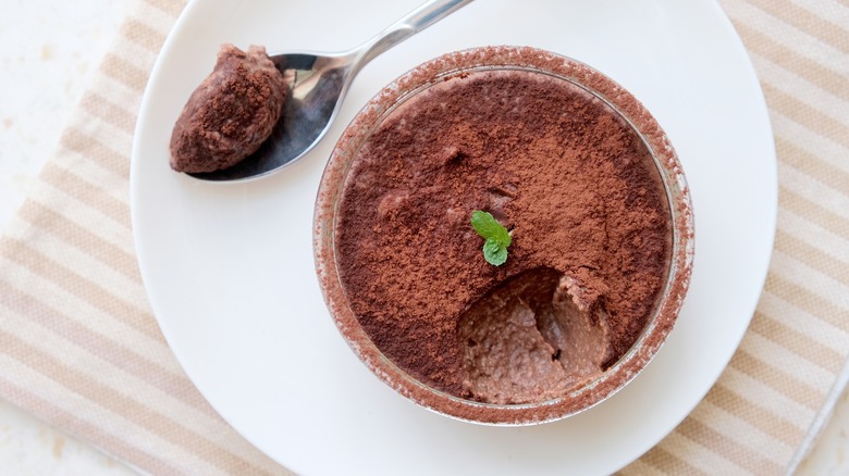 cup of chocolate mousse with a spoonful taken out of it
