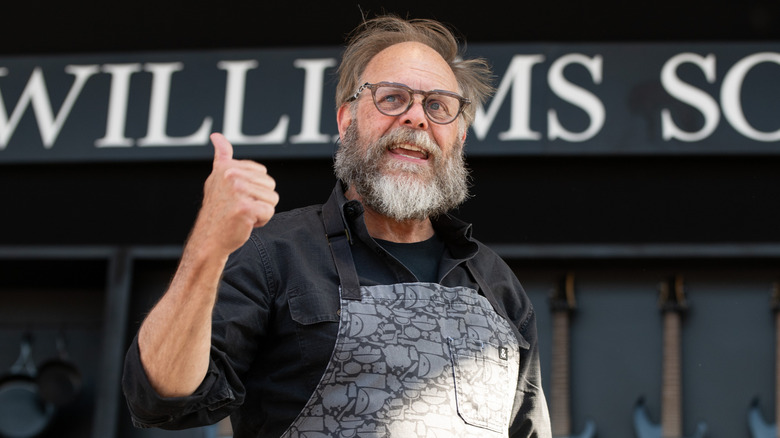 Alton Brown speaking and giving a thumbs up