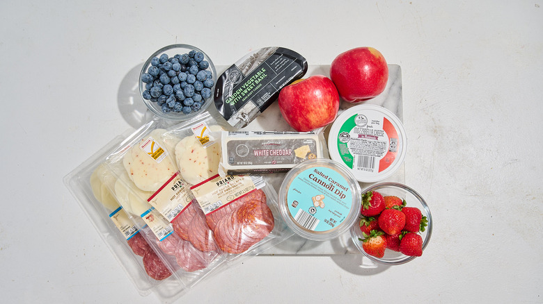 Ingredients for a snack board arranged on a serving board