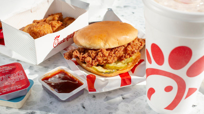 Chick-Fil-A sandwich with sauce and drink