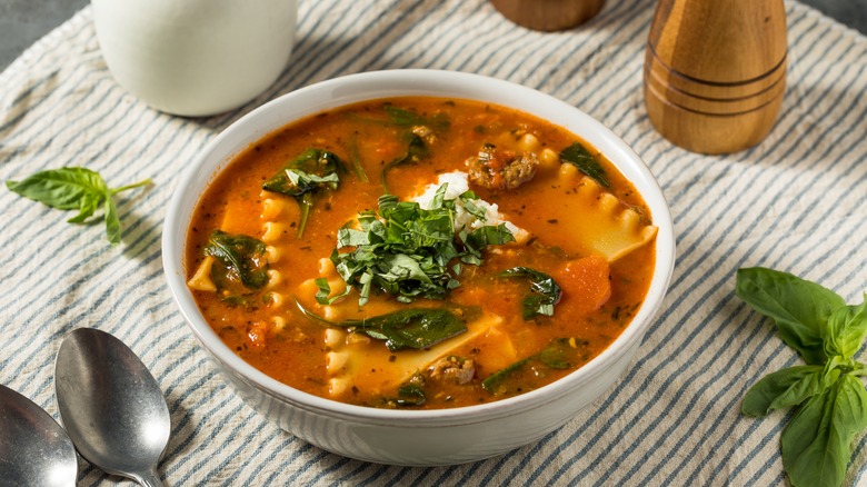 Bowl of lasagna soup on striped cloth